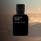 Black perfume bottle labeled 'Desert Hope' against a desert landscape with a person in the distance.